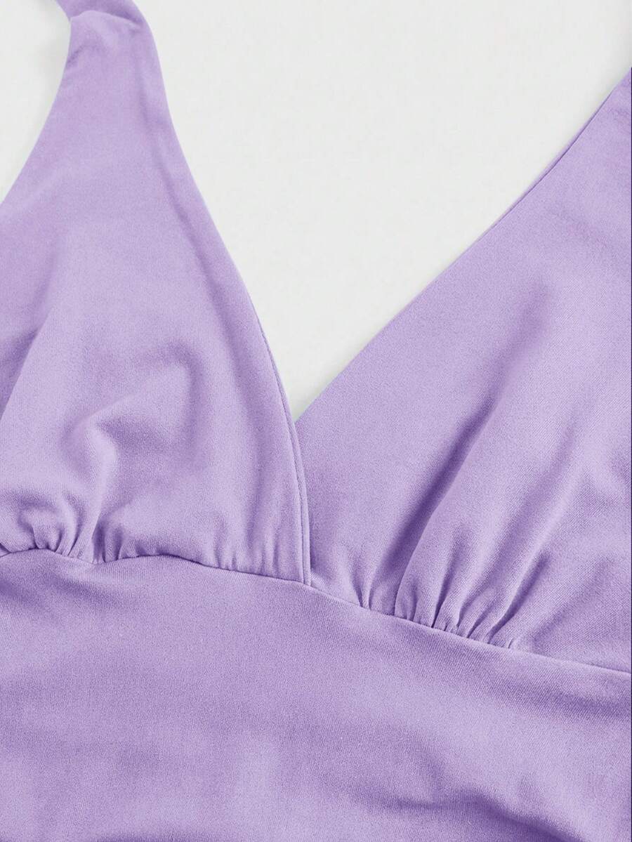 Women's halter crop tank top featuring a backless silhouette and ruched detailing in a slim fit design.