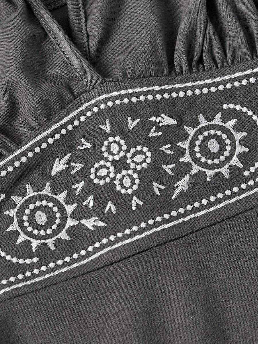 Women's sun totem embroidered sleeveless layered mini dress featuring a halter neck, backless tie back design, and slim fit high-waist A-line silhouette.