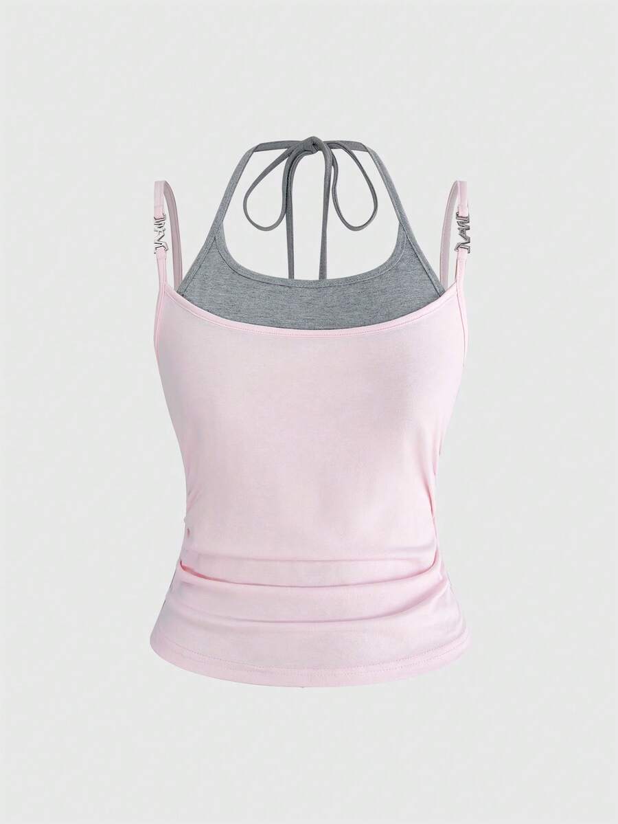 Black halter crop tank top featuring lace-up front details, ruched texture, eye appliques, and matching detached arm sleeves.