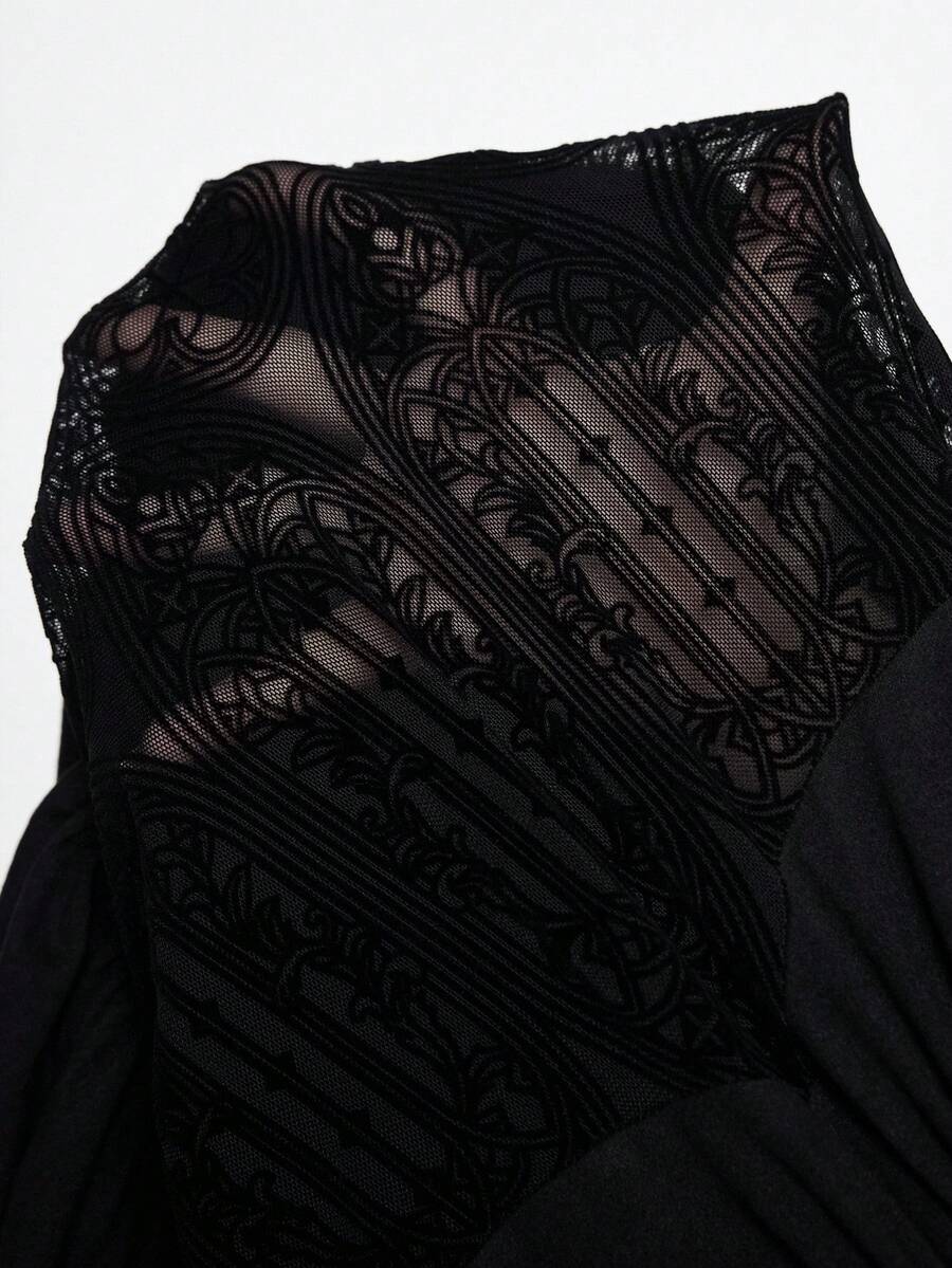 Women's black gothic mini dress featuring a halter neck, cut-out waist, contrast lace details, and an asymmetrical hem.