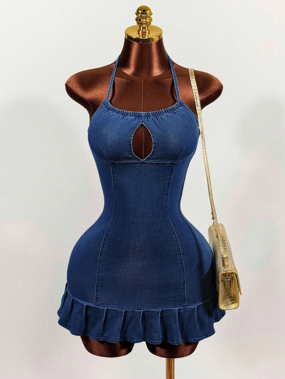 Women's blue denim halter mini dress featuring front cut-out details and a flounce ruffle hem.