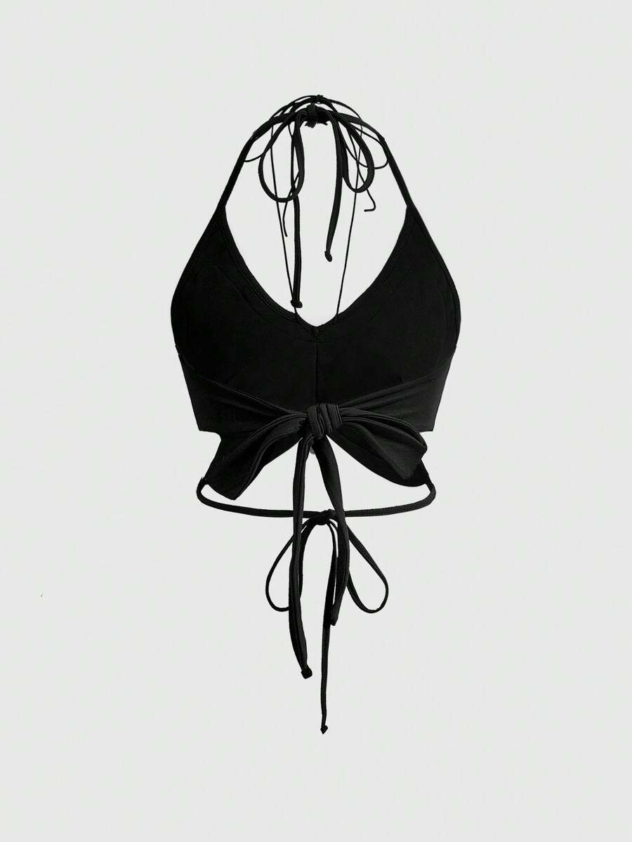 Black gothic halter crop tank top featuring a butterfly skeleton applique, front twist detail, and asymmetrical hem on slim-fit stretch fabric.