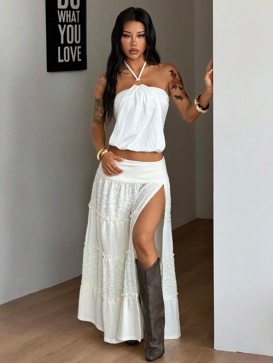 Women's black low waist split thigh long skirt featuring semi-sheer textured fabric and a flared skinny fit.