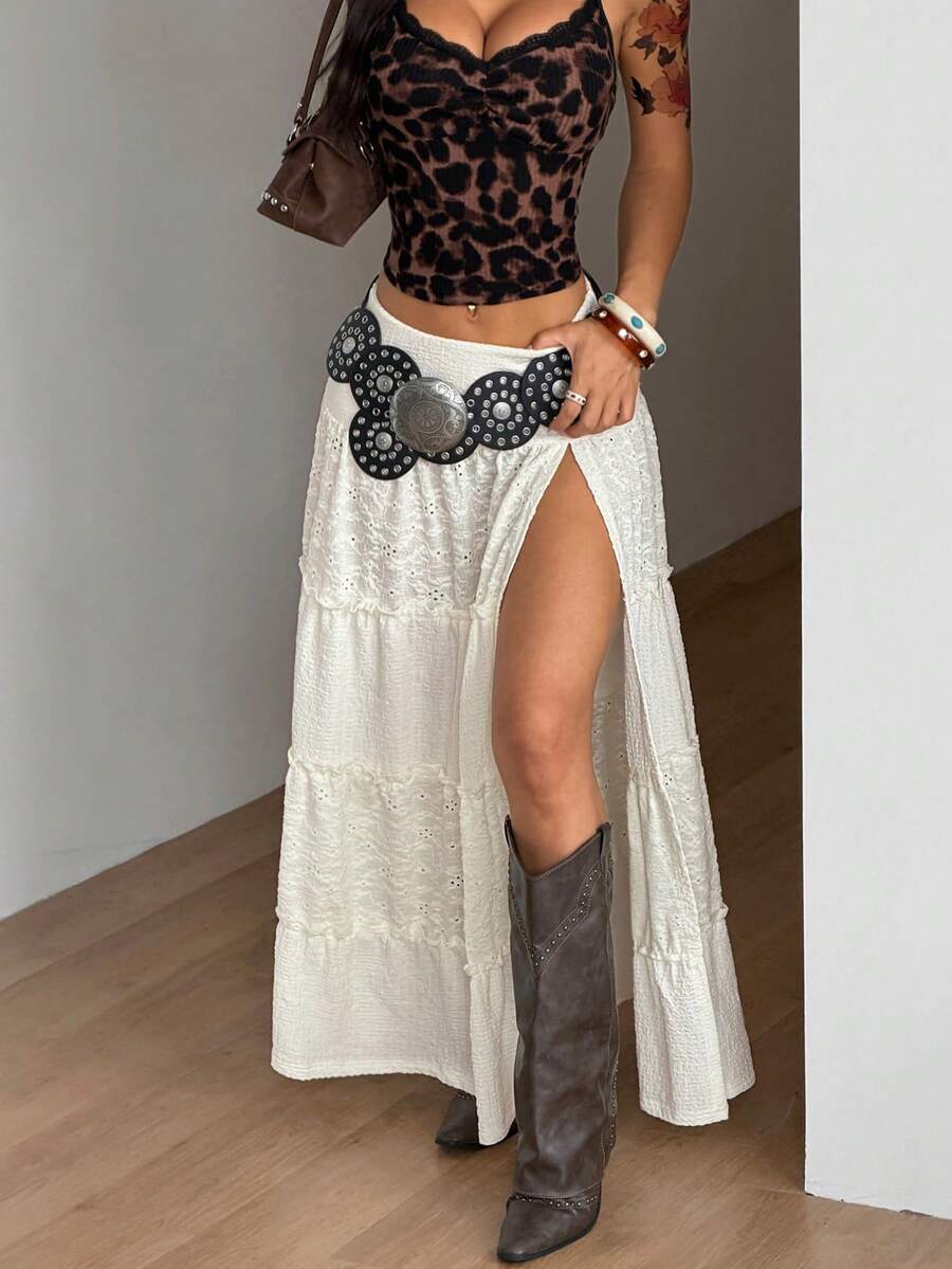 Women's black low waist split thigh long skirt featuring semi-sheer textured fabric and a flared skinny fit.