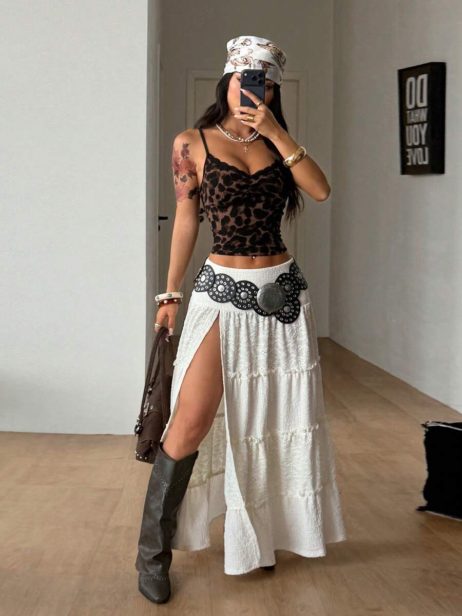 Women's black low waist split thigh long skirt featuring semi-sheer textured fabric and a flared skinny fit.