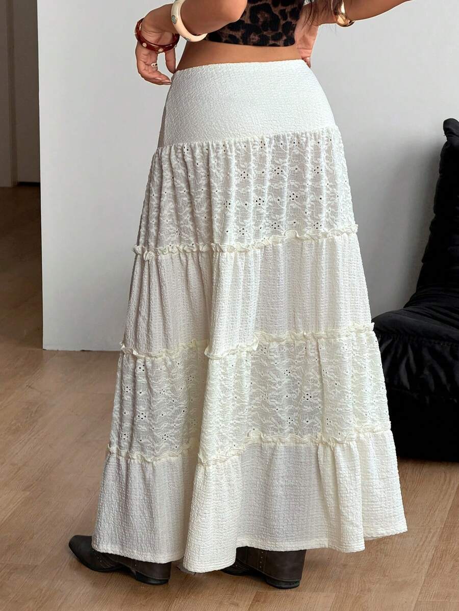Women's black low waist split thigh long skirt featuring semi-sheer textured fabric and a flared skinny fit.