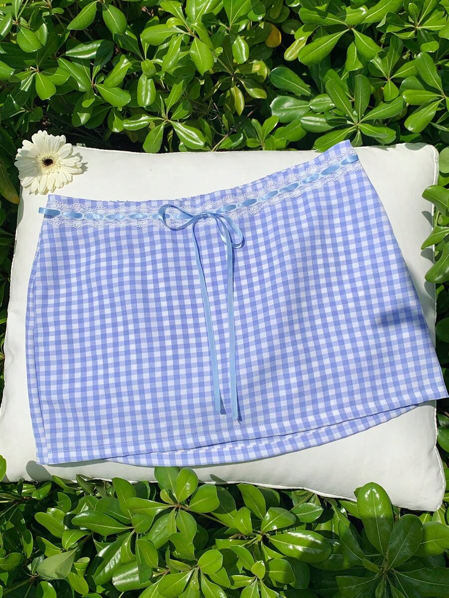 Women's white 100% cotton low waist mini skirt featuring a tropical print and zipper detail.