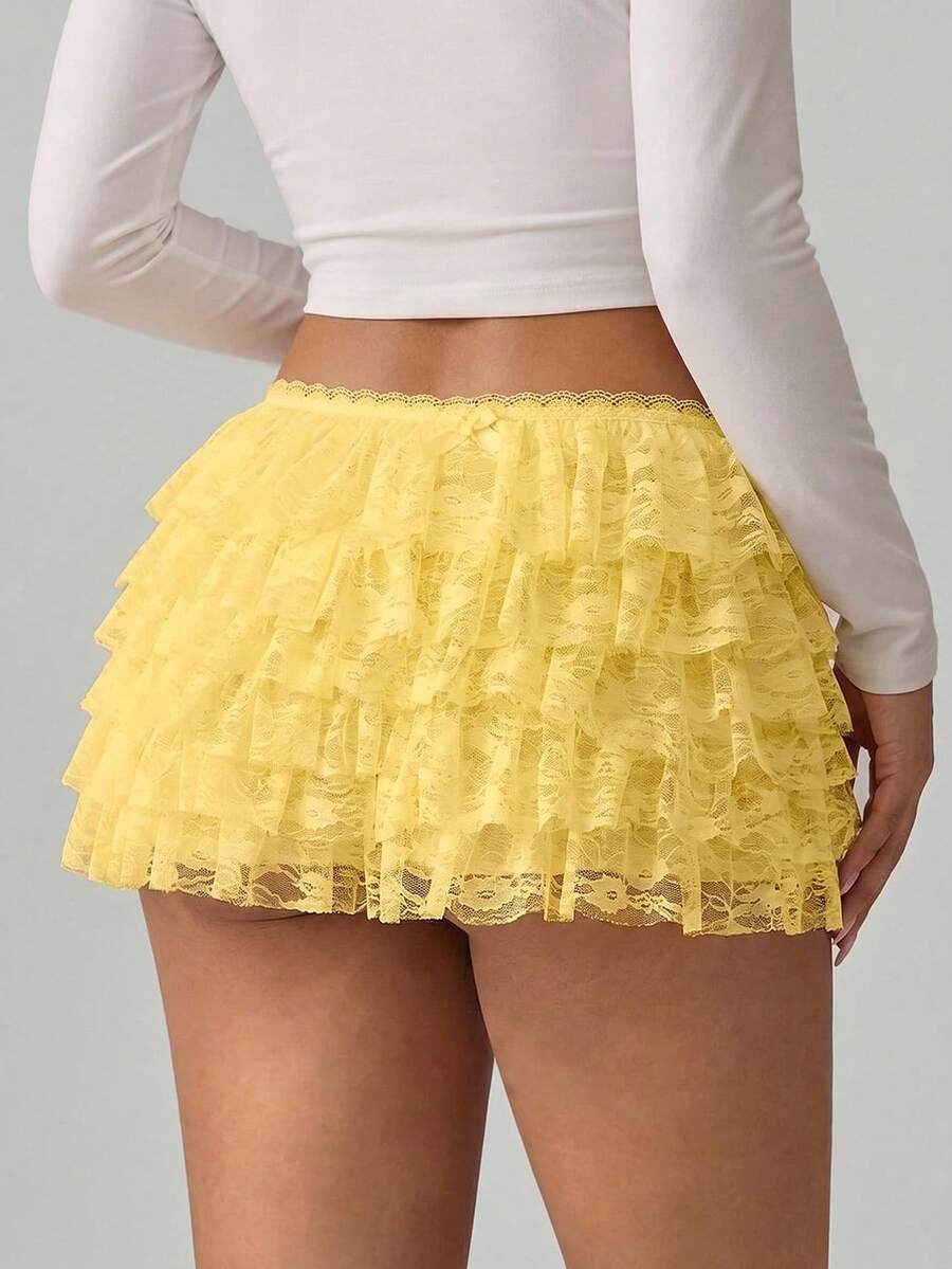 Apricot tiered lace ruffle hem low waist shorts for women featuring elastic waist and lined semi-sheer knit fabric.