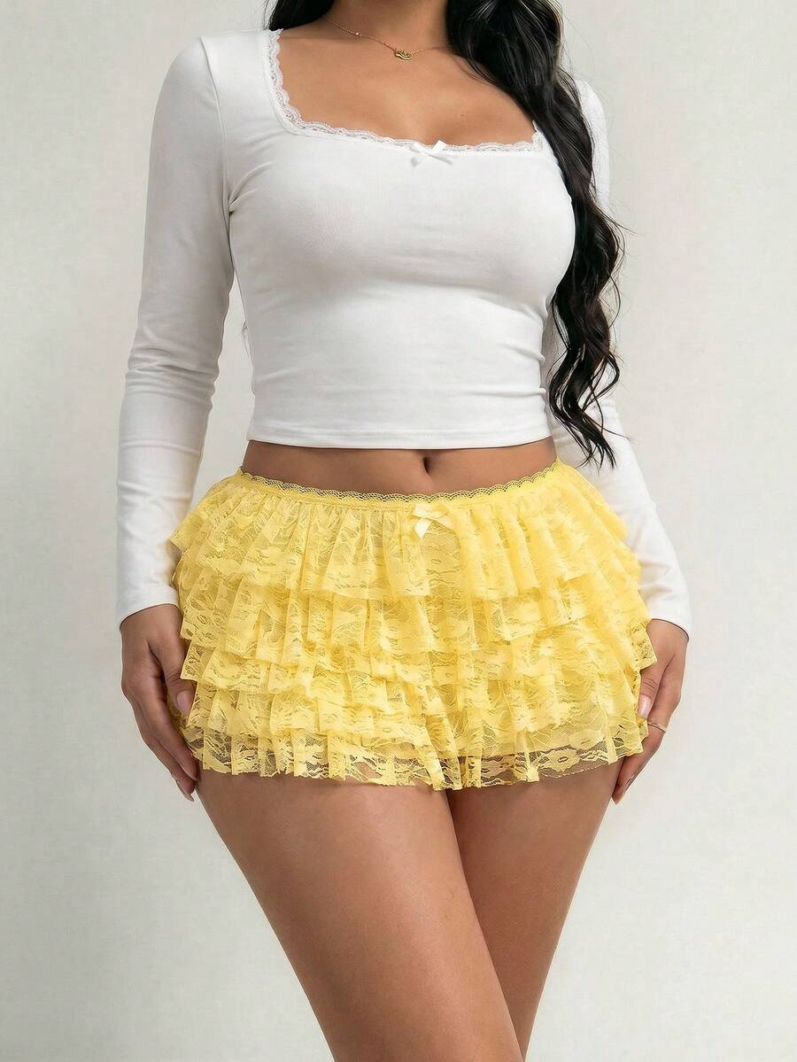Apricot tiered lace ruffle hem low waist shorts for women featuring elastic waist and lined semi-sheer knit fabric.