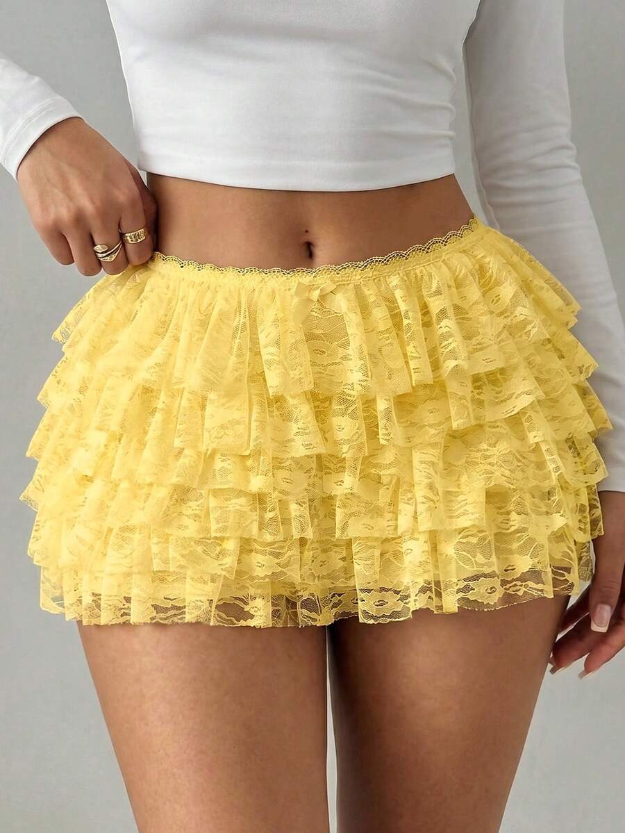 Apricot tiered lace ruffle hem low waist shorts for women featuring elastic waist and lined semi-sheer knit fabric.