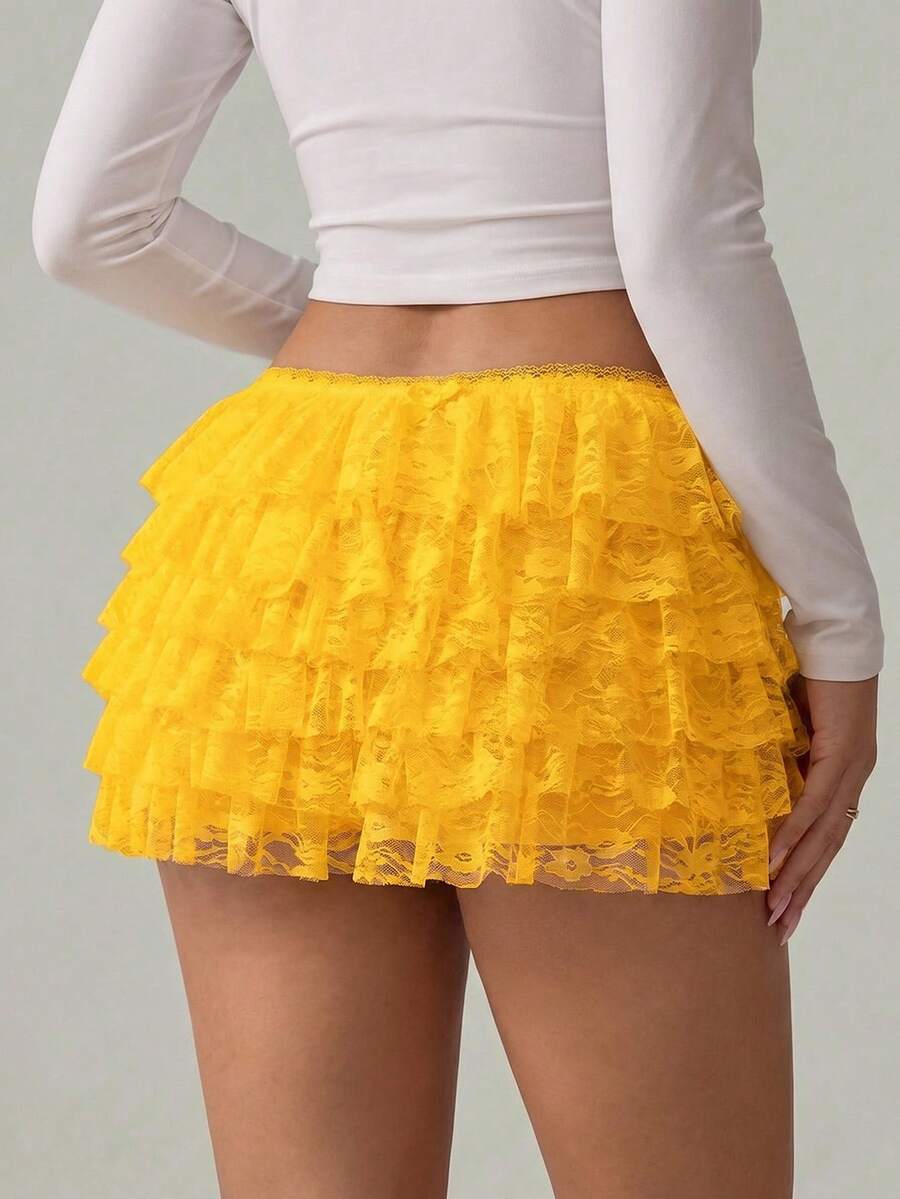 Apricot tiered lace ruffle hem low waist shorts for women featuring elastic waist and lined semi-sheer knit fabric.