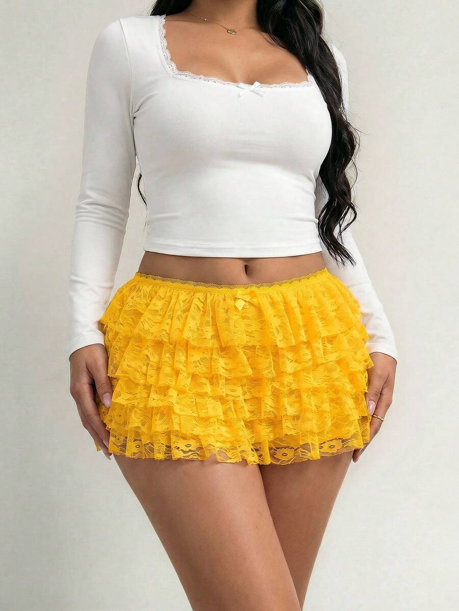 Apricot tiered lace ruffle hem low waist shorts for women featuring elastic waist and lined semi-sheer knit fabric.