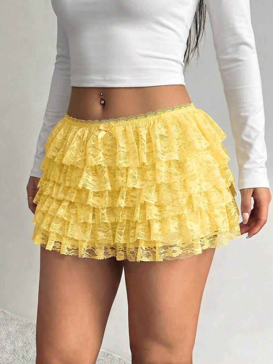 Apricot tiered lace ruffle hem low waist shorts for women featuring elastic waist and lined semi-sheer knit fabric.