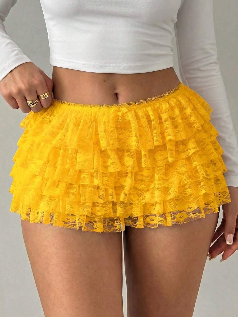 Apricot tiered lace ruffle hem low waist shorts for women featuring elastic waist and lined semi-sheer knit fabric.
