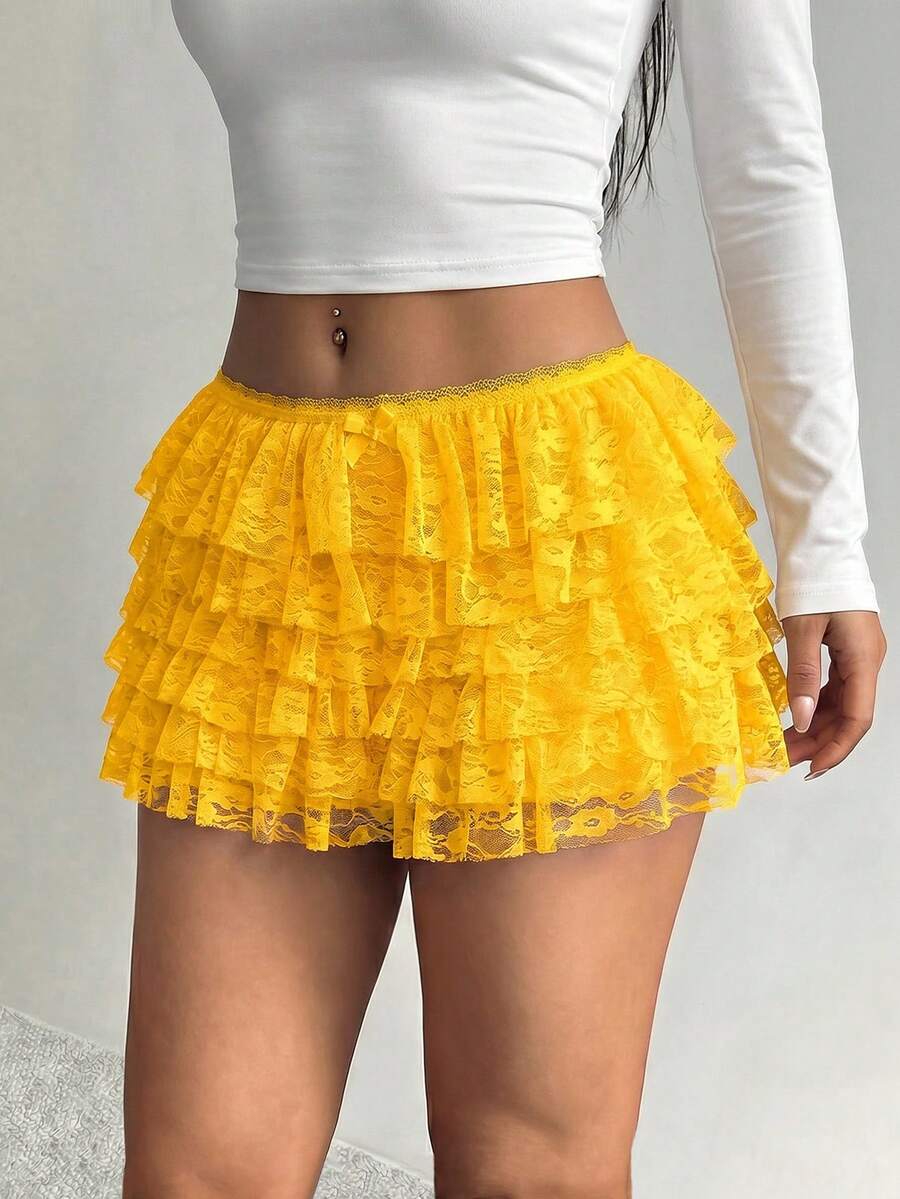 Apricot tiered lace ruffle hem low waist shorts for women featuring elastic waist and lined semi-sheer knit fabric.