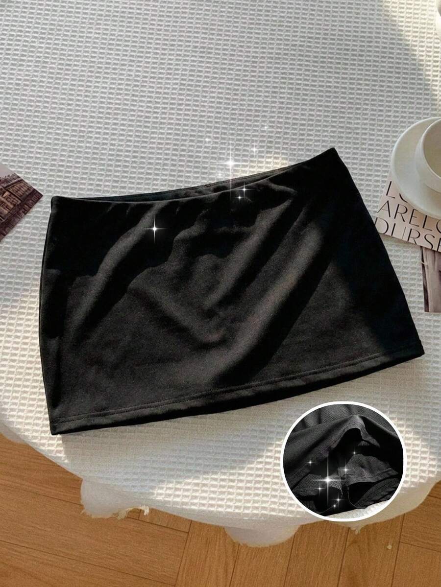 Tween girl solid black casual mini skirt featuring built-in shorts made from stretch fabric.