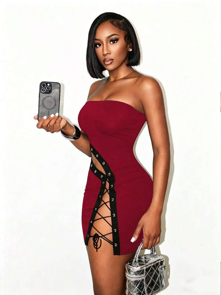 Women's black strapless bodycon mini dress featuring an asymmetrical lace-up design with grommet eyelets and a slim pencil fit.