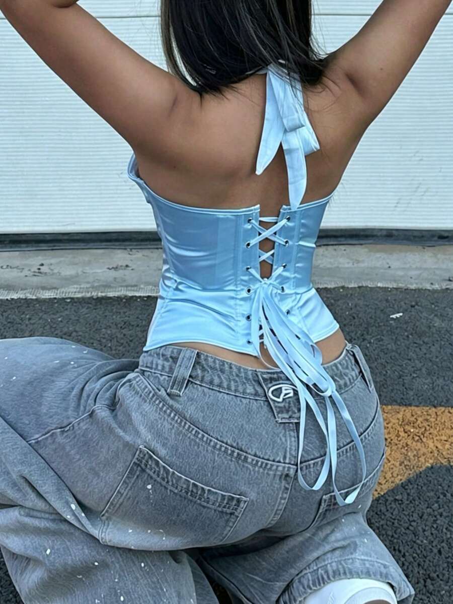 White satin corset crop top featuring a halter neck, slim fit, and back lace-up design.
