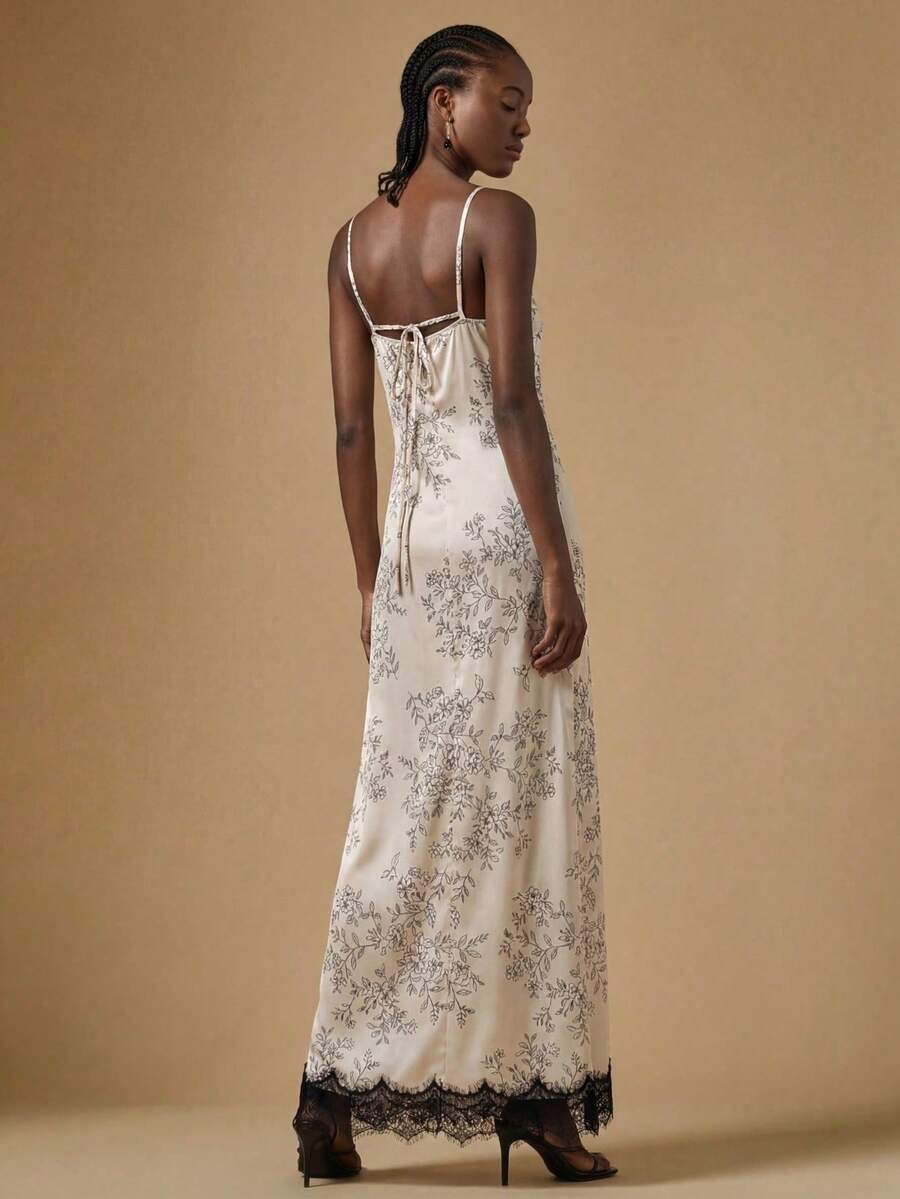 Women's black lace split satin long dress featuring spaghetti straps, asymmetrical slit hem, and matching arm sleeves.