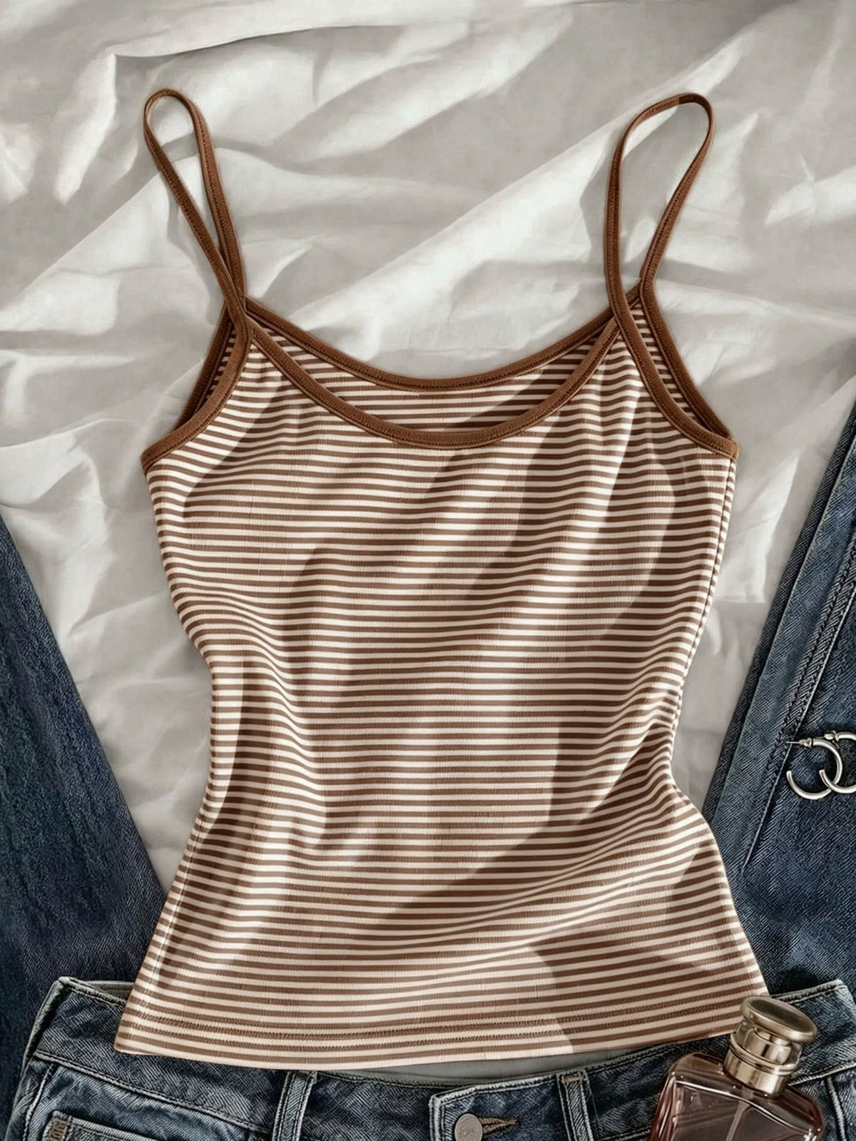 Women's pink striped crop camisole featuring criss cross spaghetti straps and slim fit design.