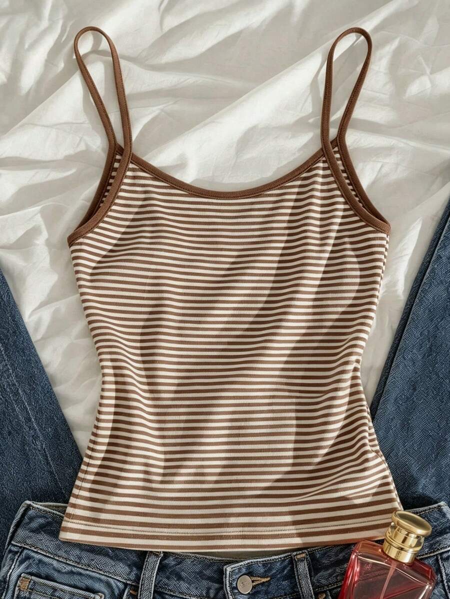 Women's pink striped crop camisole featuring criss cross spaghetti straps and slim fit design.