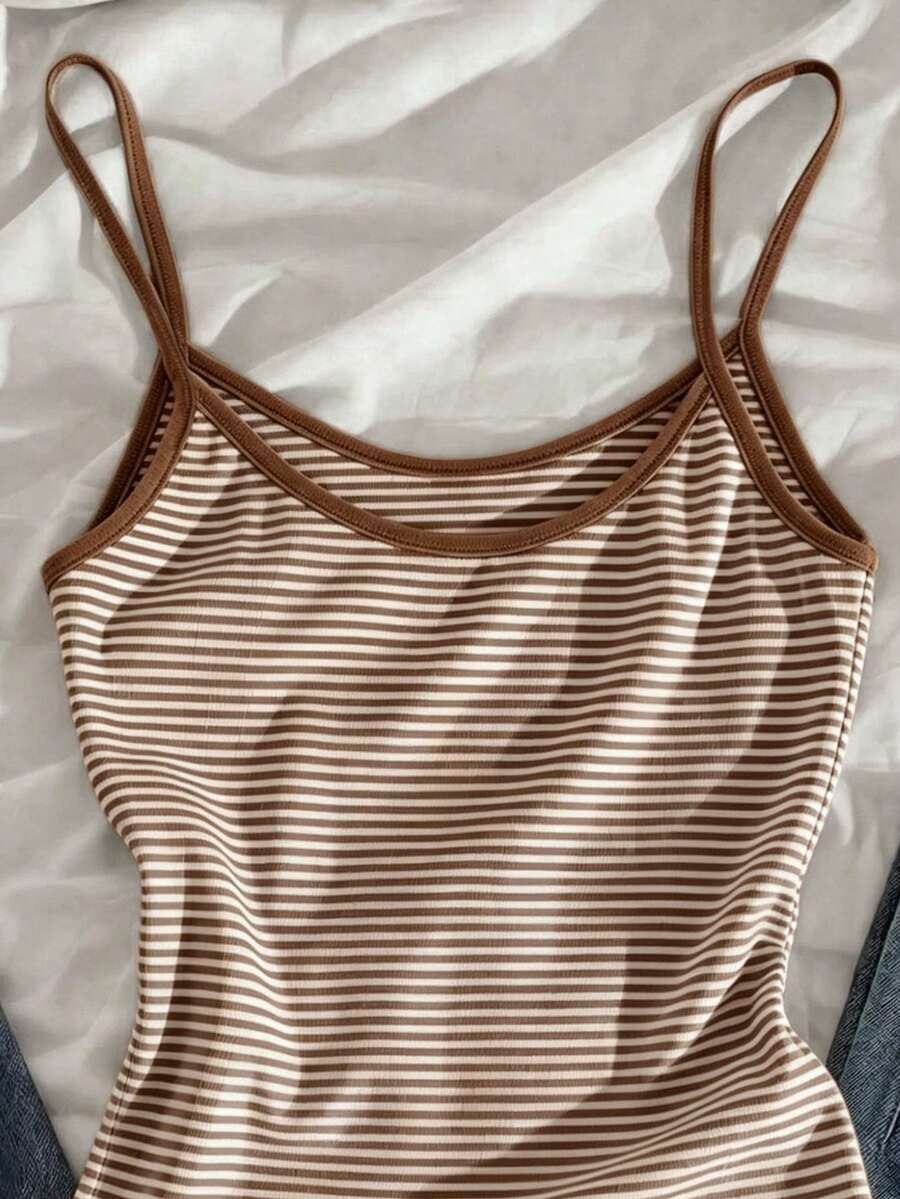 Women's pink striped crop camisole featuring criss cross spaghetti straps and slim fit design.