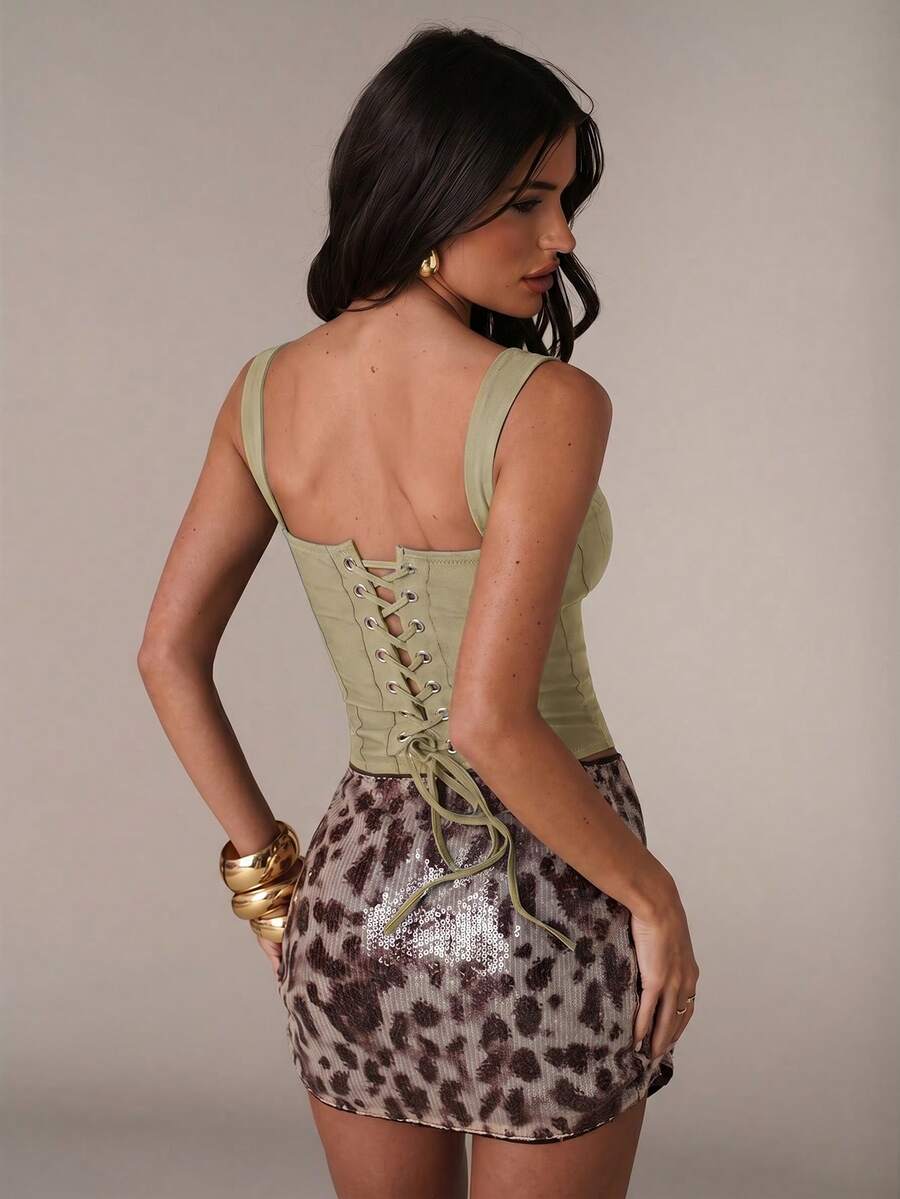 Women's slim fit tank top with rhinestone detail, wide straps, and a short length for casual beach wear.
