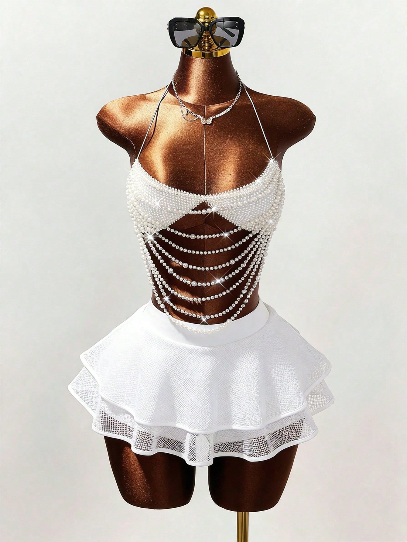 Women's black Y2K rhinestone layered mini skirt with hollow-out detailing and natural mid-waist design