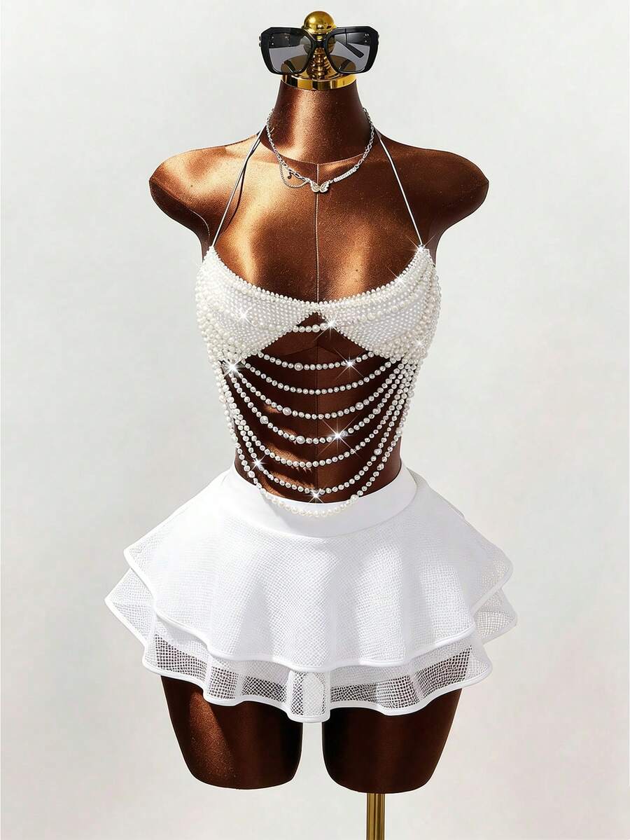 Women's black Y2K rhinestone layered mini skirt with hollow-out detailing and natural mid-waist design