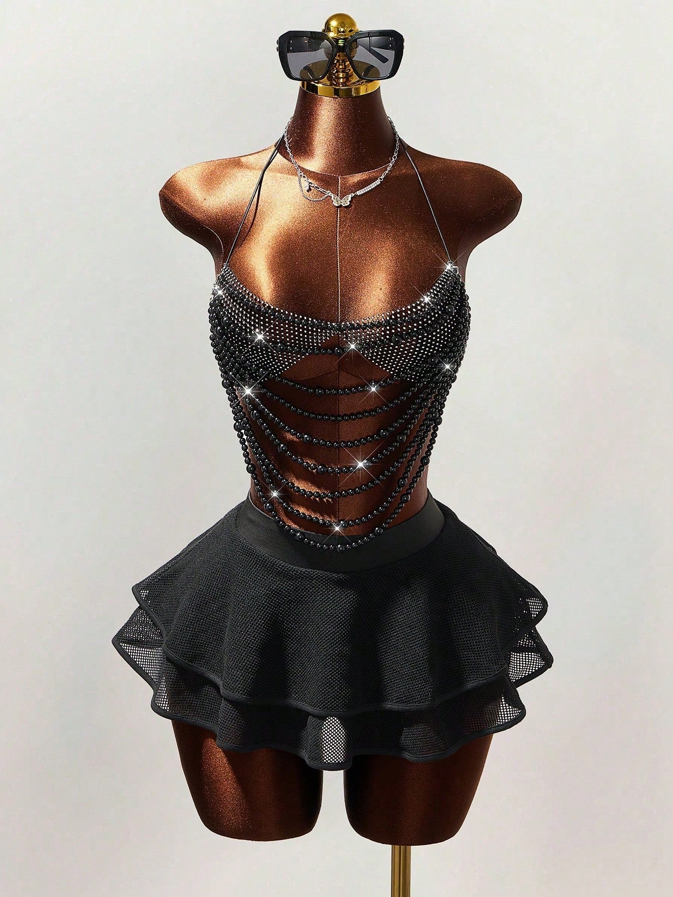 Women's black Y2K rhinestone layered mini skirt with hollow-out detailing and natural mid-waist design