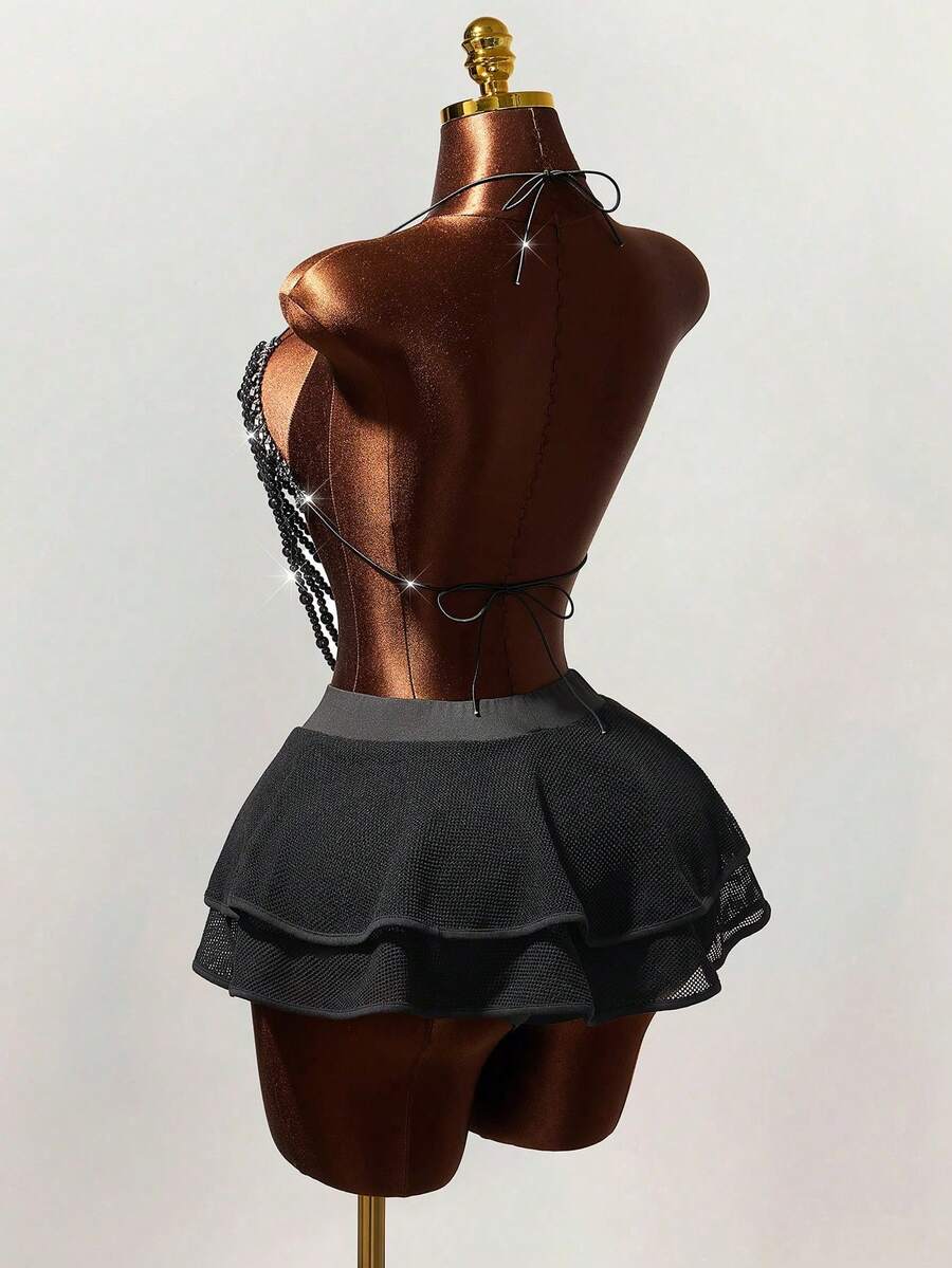 Women's black Y2K rhinestone layered mini skirt with hollow-out detailing and natural mid-waist design