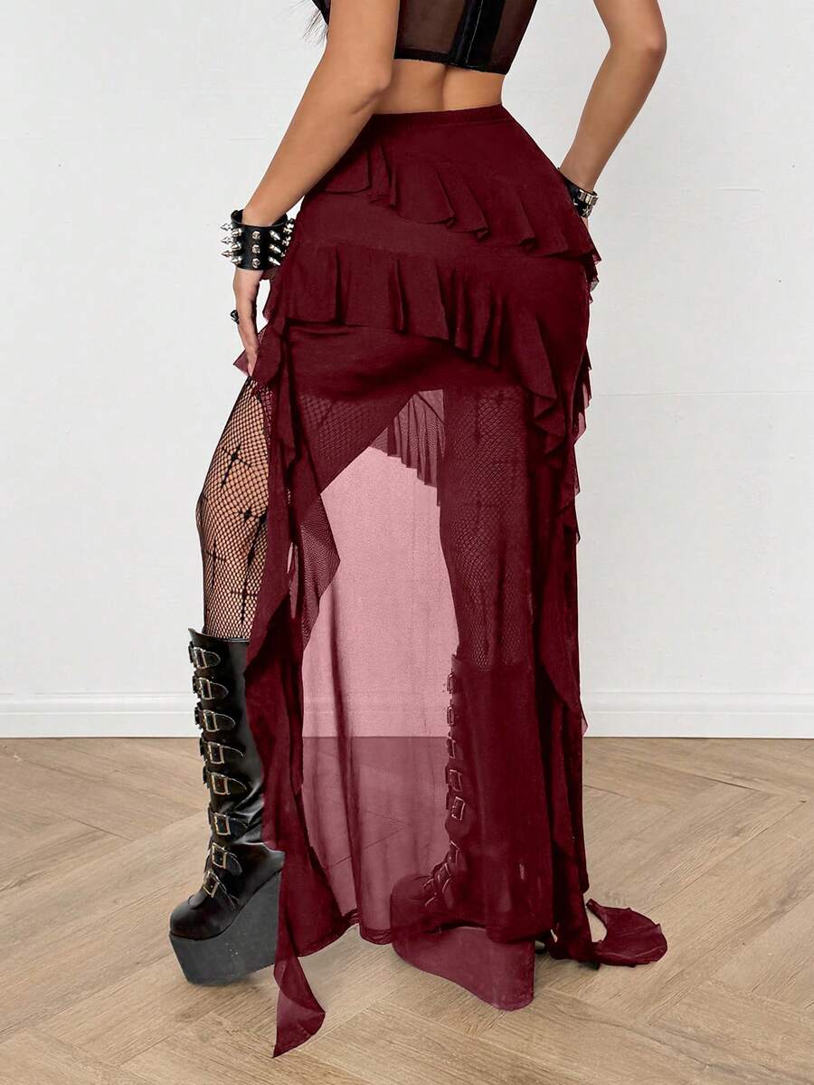 Women's black asymmetrical long skirt with ruffle hem and low waist design in knitted fabric.