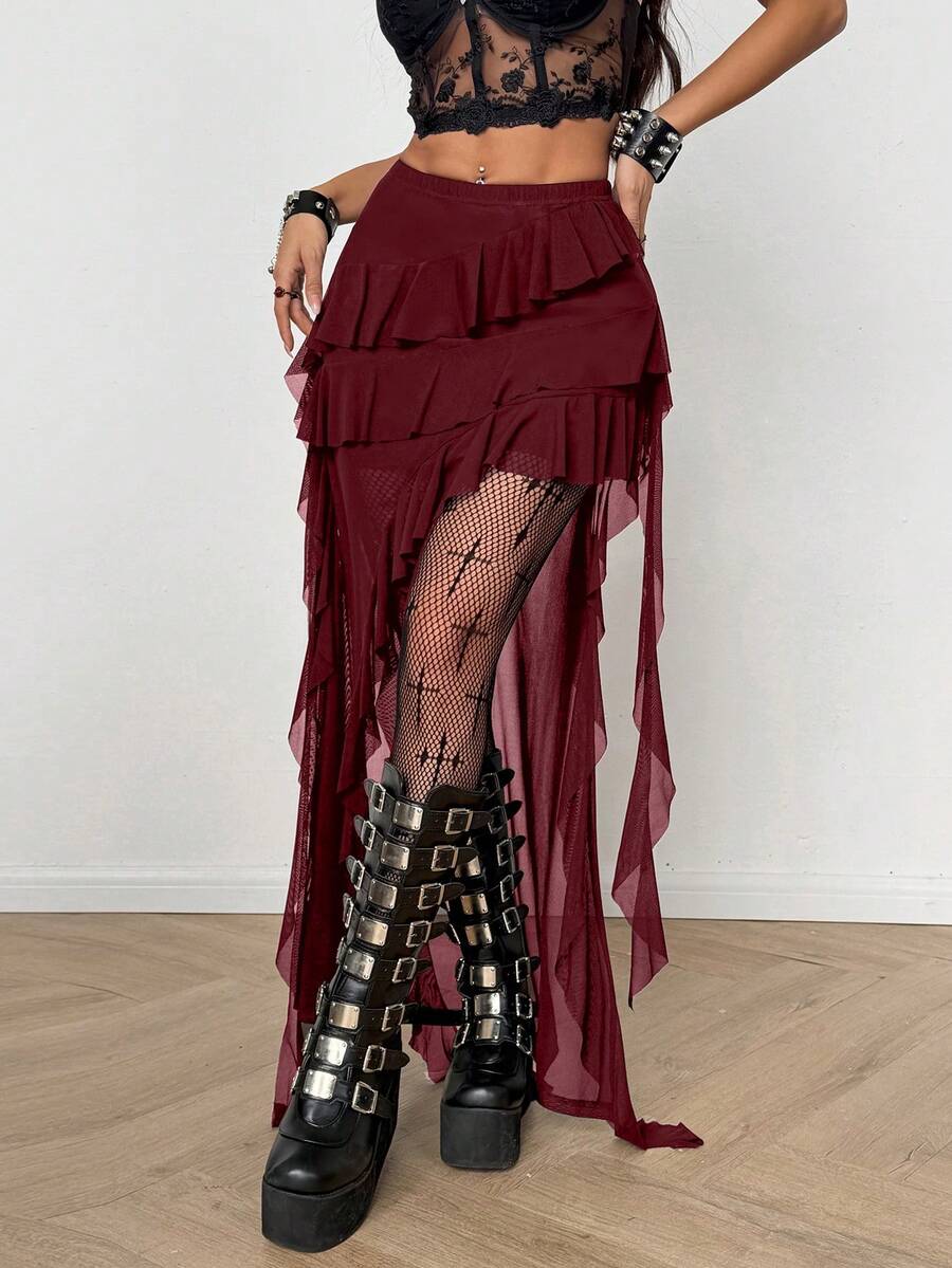 Women's black asymmetrical long skirt with ruffle hem and low waist design in knitted fabric.