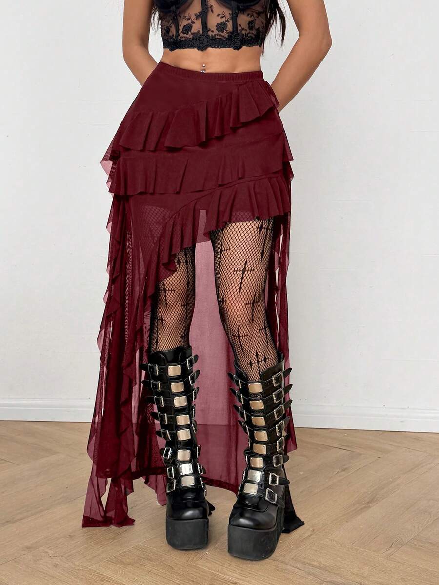 Women's black asymmetrical long skirt with ruffle hem and low waist design in knitted fabric.