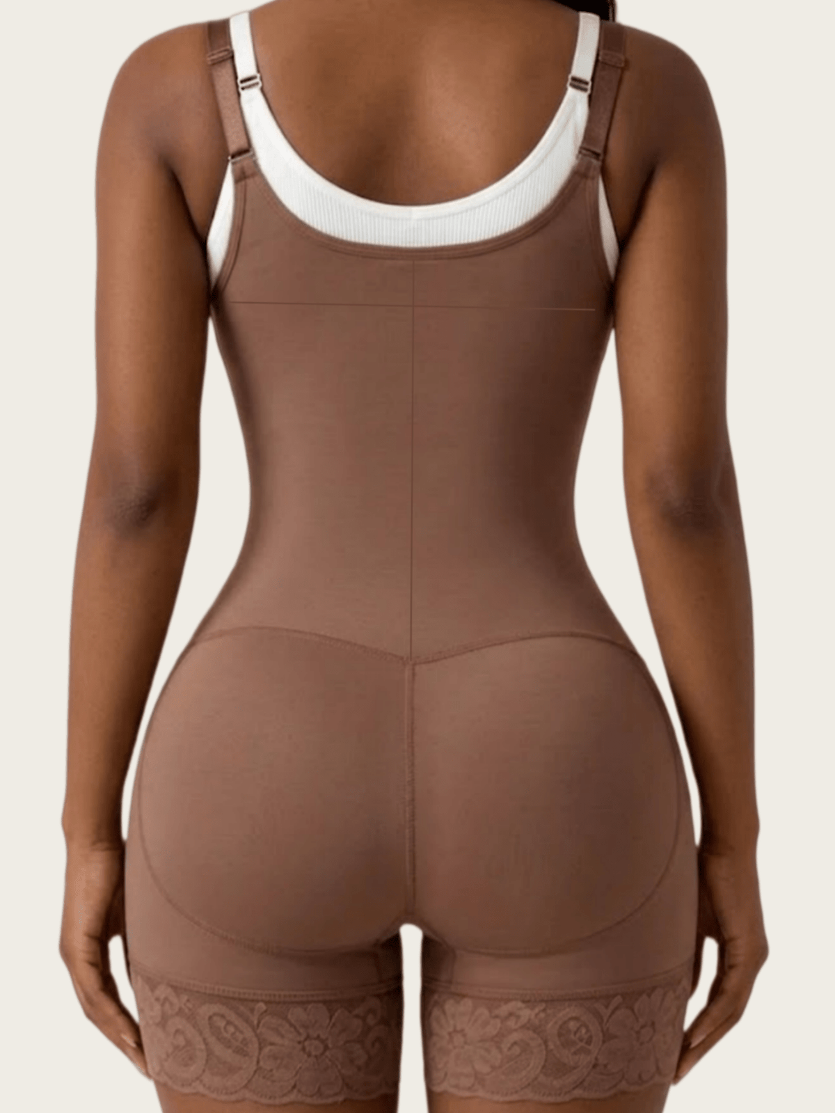Women's apricot body shaper jumpsuit with 4-row hook and eye front closure and contrast lace details.