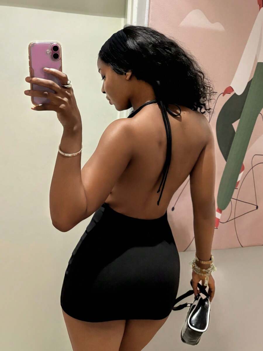 Women's black deep V-neck halter bodycon mini dress featuring a backless design with chain decor detail.