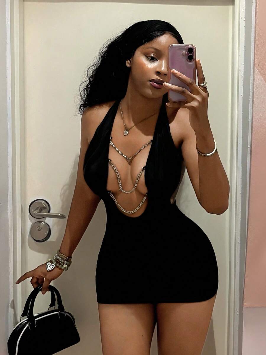 Women's black deep V-neck halter bodycon mini dress featuring a backless design with chain decor detail.