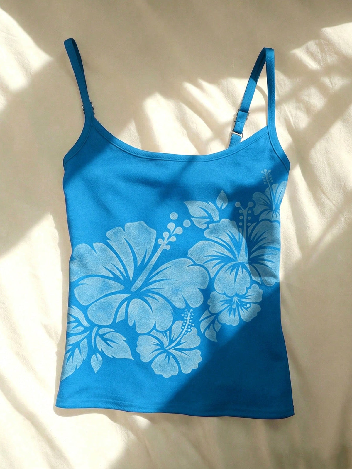 Women's blue floral print spaghetti strap camisole top in a slim fit short length design