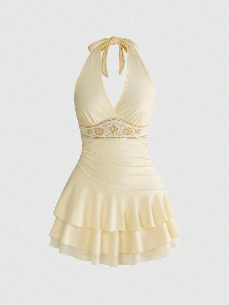 Women's sun totem embroidered sleeveless layered mini dress featuring a halter neck, backless tie back design, and slim fit high-waist A-line silhouette.