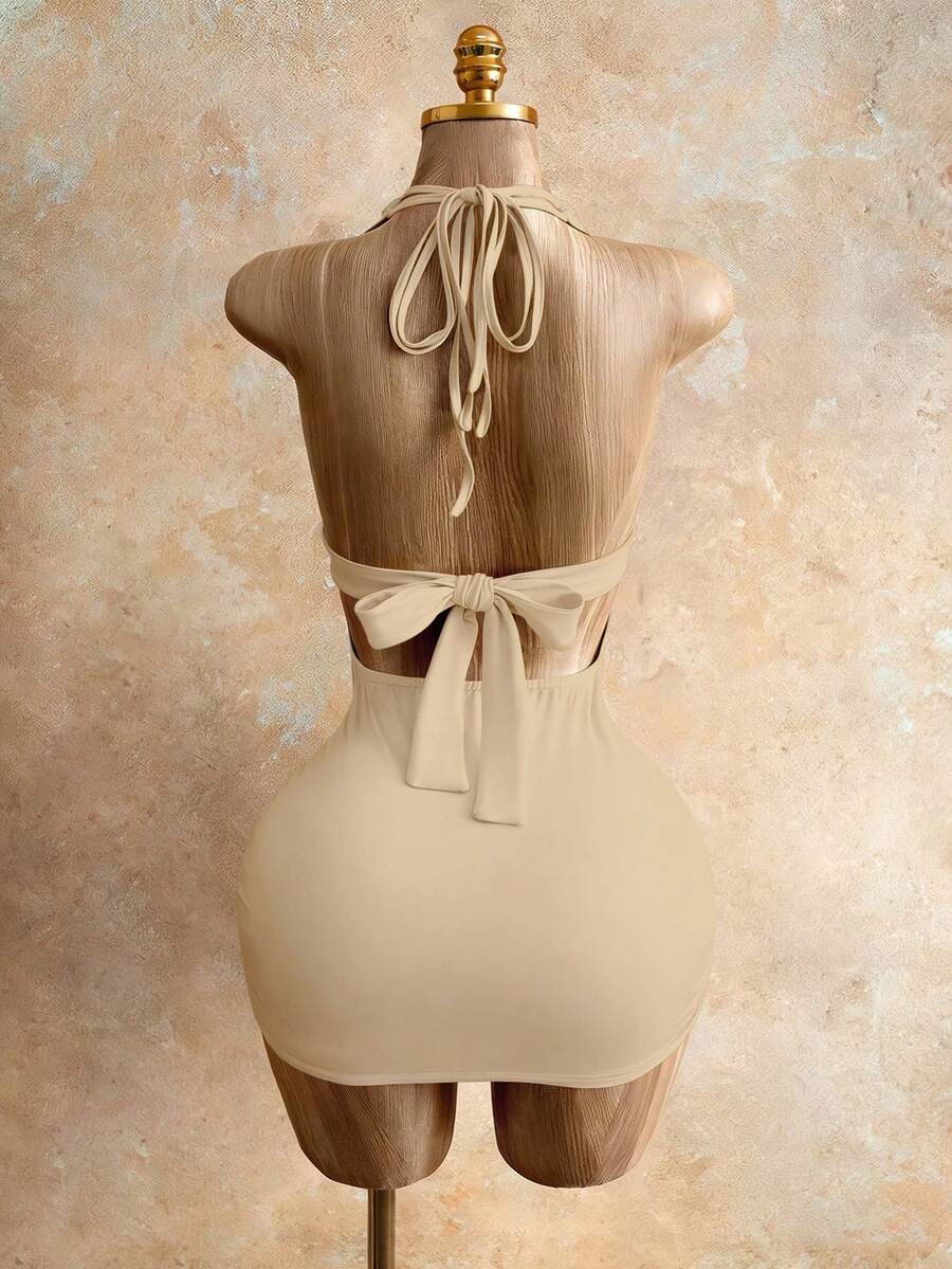 Sleeveless women's halter backless bodycon mini dress featuring lace-up knot back details and a high-waist pencil hem.
