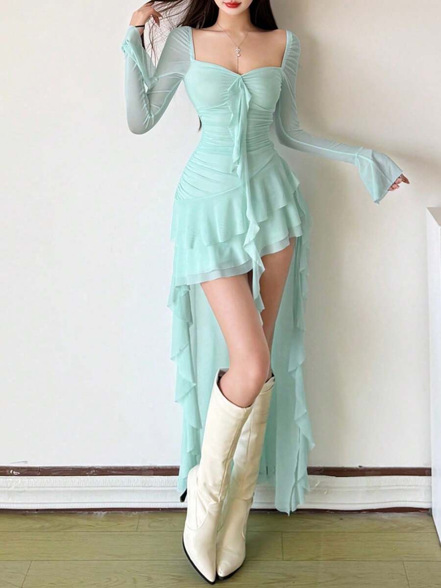 Woman wearing a solid off-the-shoulder asymmetrical midi dress with long flare sleeves.