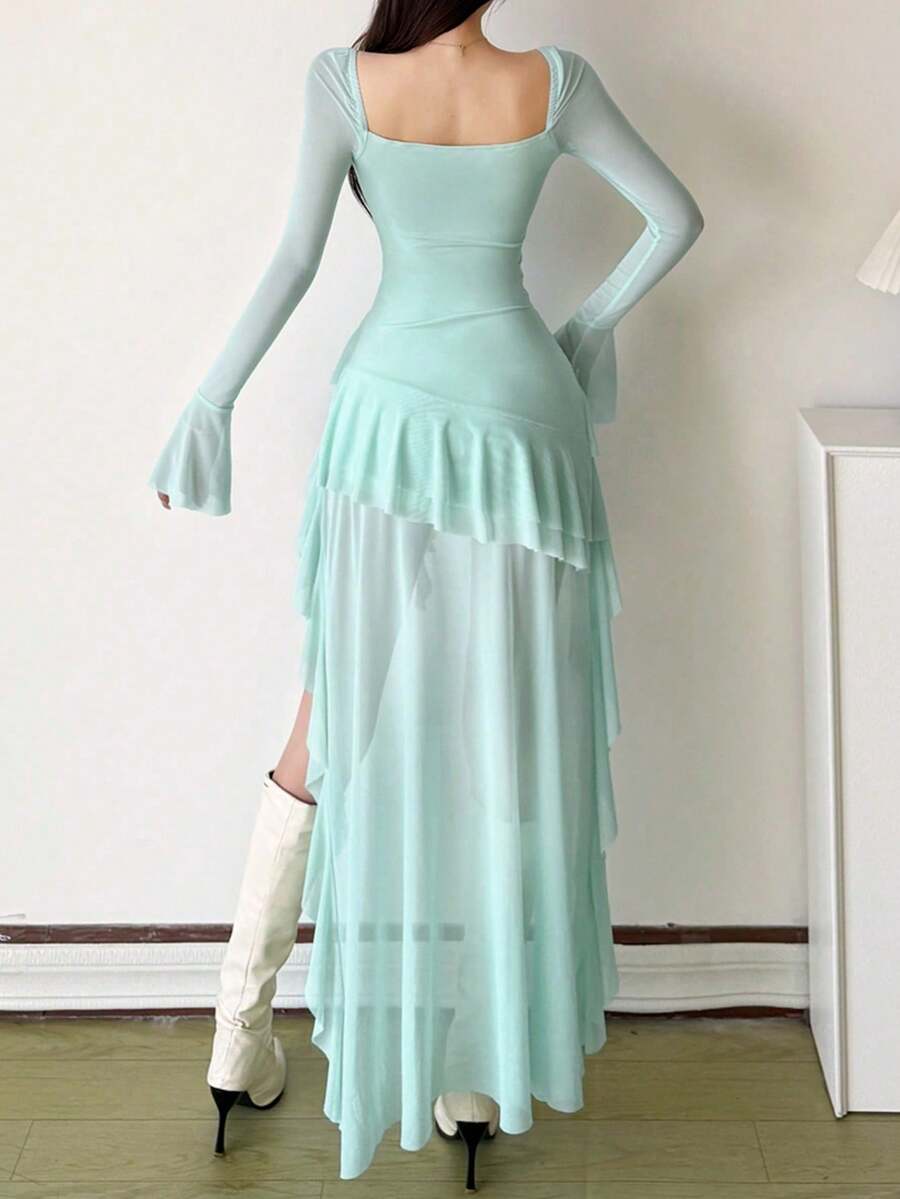Woman wearing a solid off-the-shoulder asymmetrical midi dress with long flare sleeves.