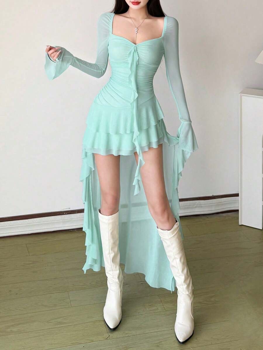 Woman wearing a solid off-the-shoulder asymmetrical midi dress with long flare sleeves.