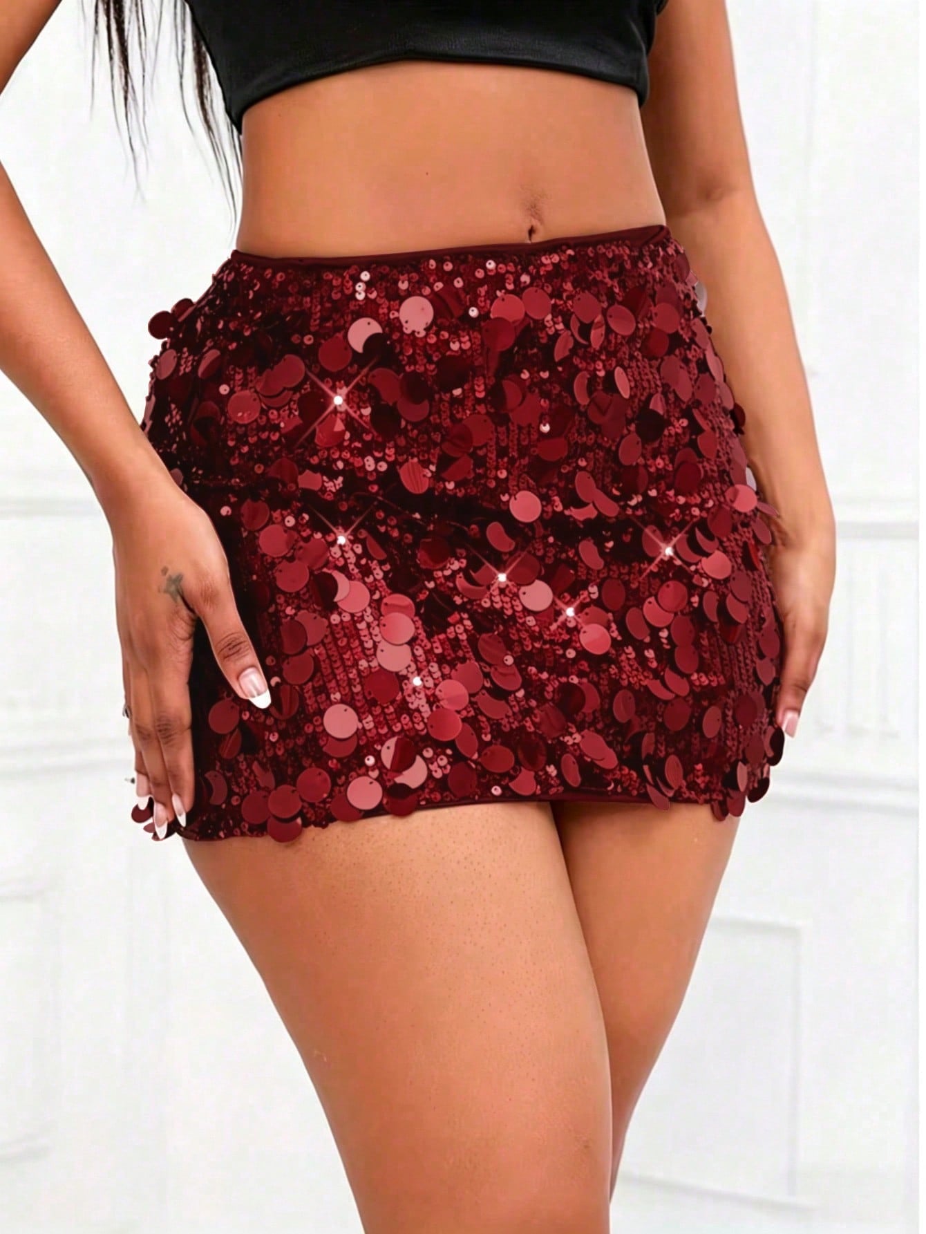 Women's high waist black sequin bodycon mini skirt featuring sparkling embellishments, unlined polyester fabric, ideal for night out and party wear.