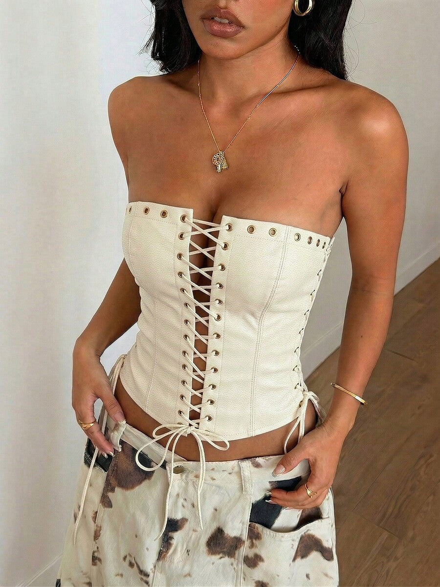 Women’s coffee brown faux leather lace-up crop top with strapless neckline, slit hem, and slim fitted silhouette for festival and nightlife wear.