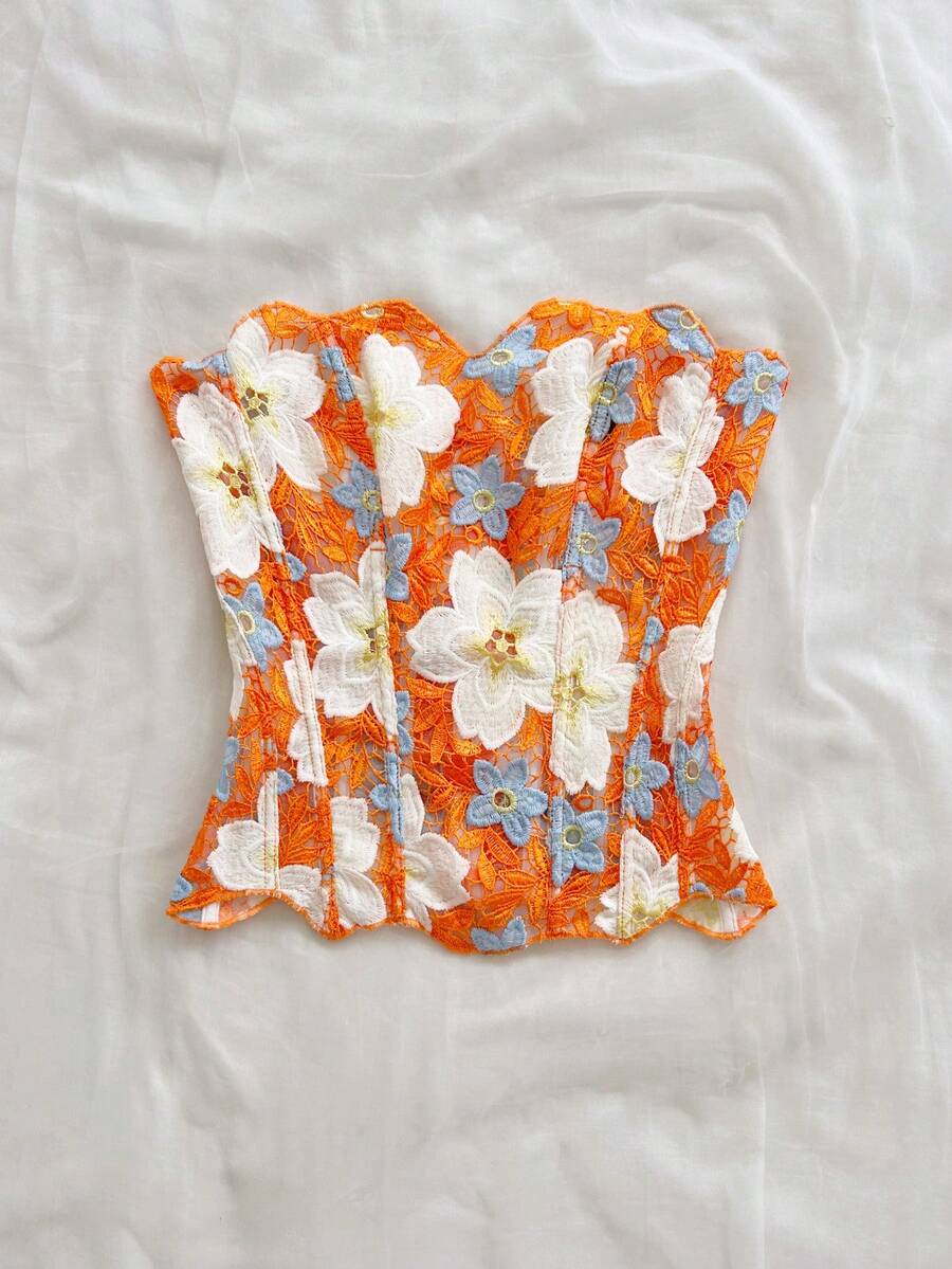 Strapless floral lace corset top with lace-up detail, asymmetrical hem, and slim fit for women.