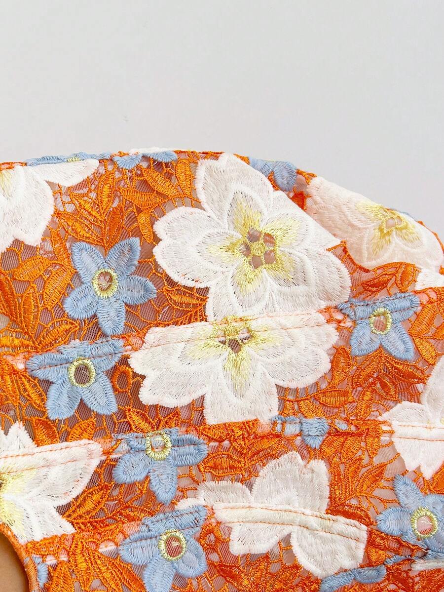 Strapless floral corset top with lace-up detail, asymmetrical hem, and slim fit for women in a boho vacation style.