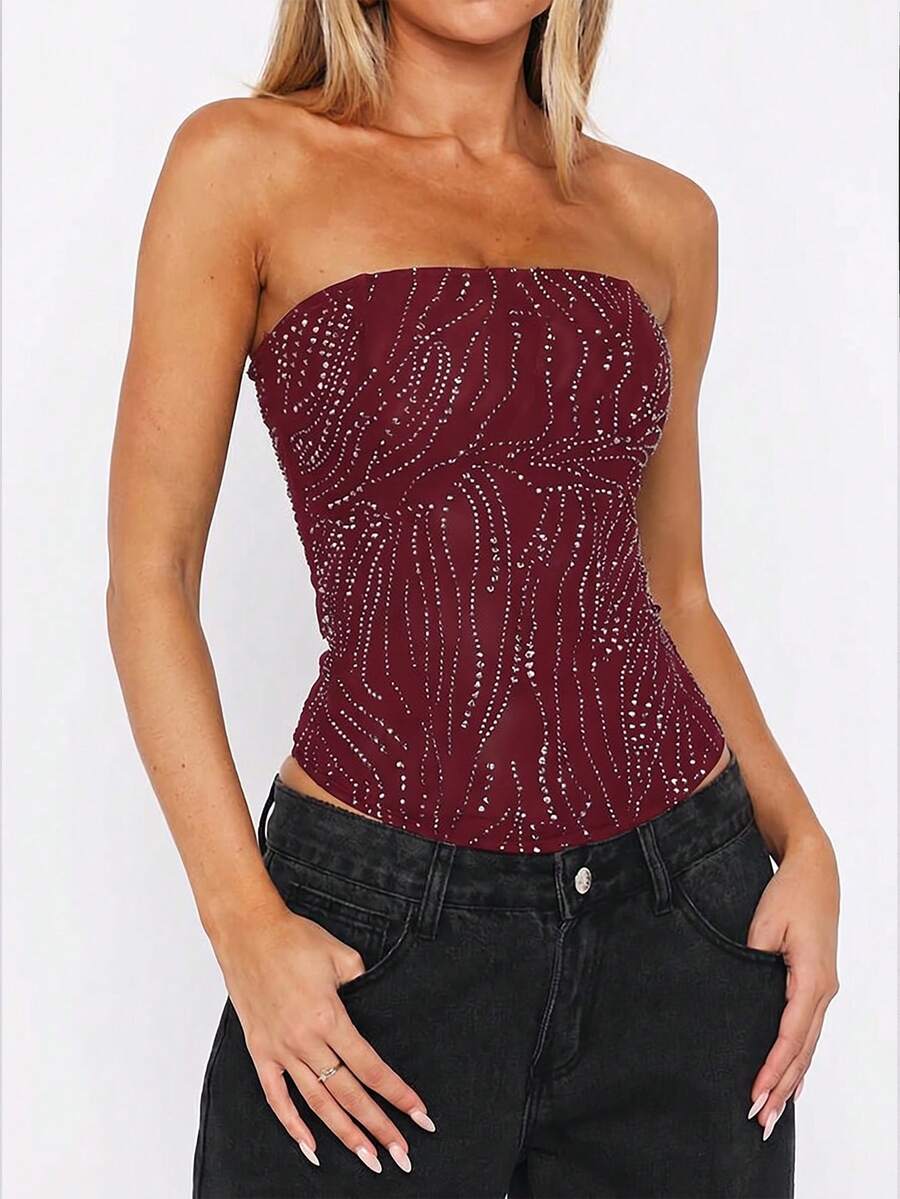Black strapless corset tube top with sparkling rhinestone decor, boned silhouette, and lace-up tie back.