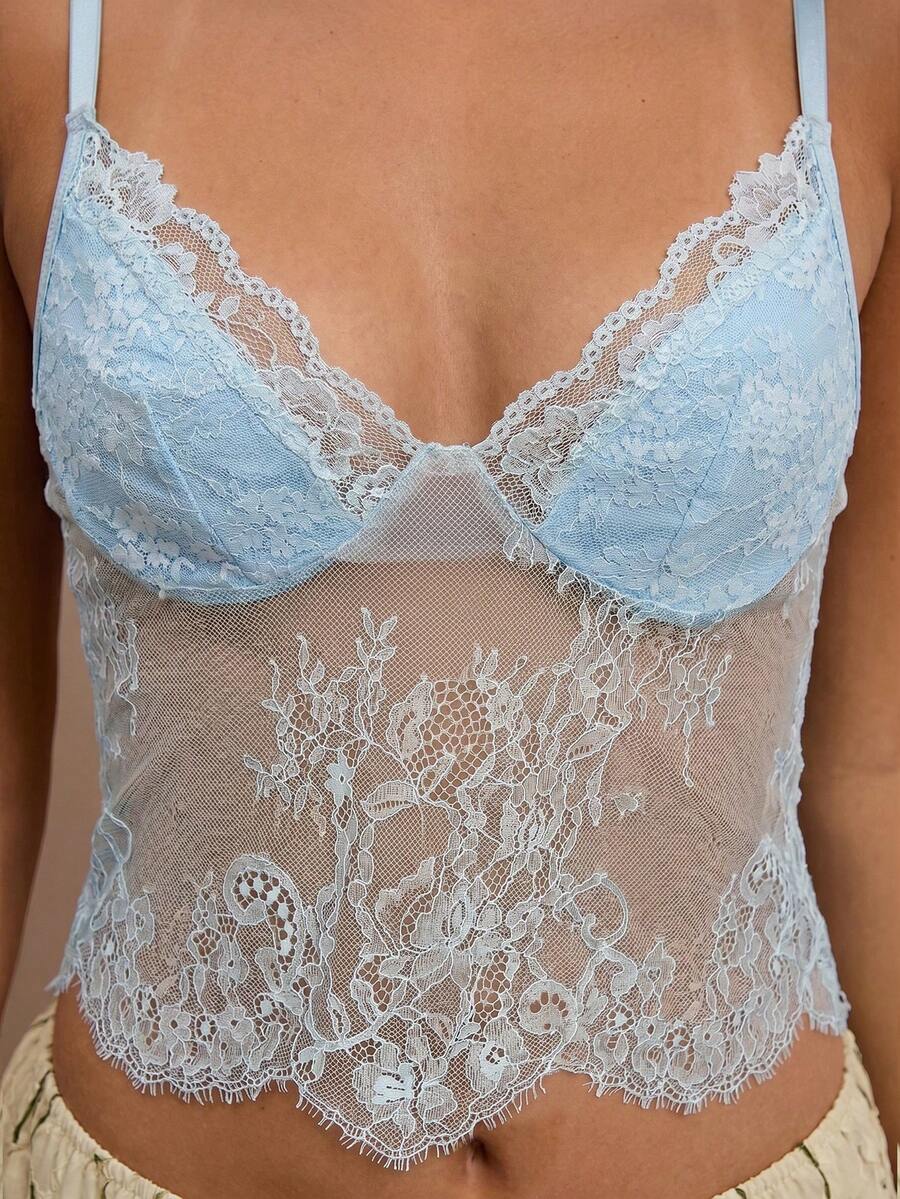 Black floral lace cropped camisole top for women featuring delicate spaghetti straps, cup detail, and semi-sheer contrast lace.
