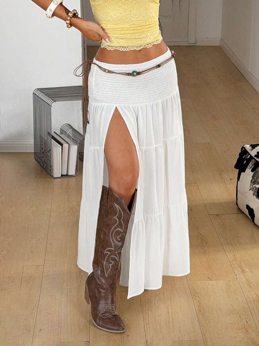 Women's black low waist split thigh long skirt featuring semi-sheer textured fabric and a flared skinny fit.